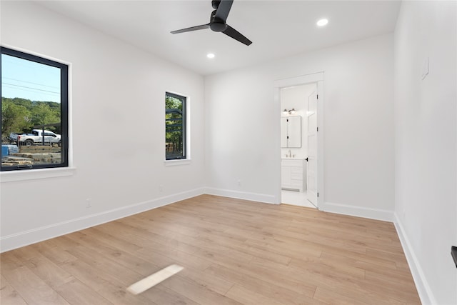 unfurnished room featuring ceiling fan, light hardwood / wood-style flooring, and plenty of natural light