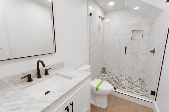 bathroom featuring walk in shower, vanity, toilet, and tile patterned floors