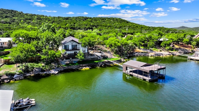 drone / aerial view featuring a water and mountain view