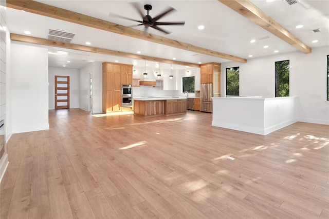 unfurnished living room featuring light wood-type flooring, ceiling fan, and beamed ceiling