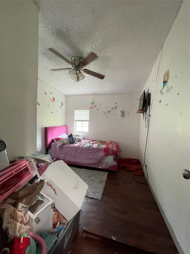 bedroom featuring hardwood / wood-style flooring, ceiling fan, and a textured ceiling