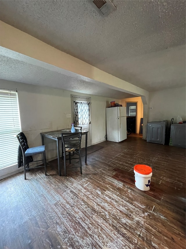 dining room featuring a textured ceiling and hardwood / wood-style flooring