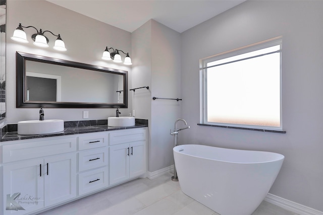 bathroom with plenty of natural light, tile flooring, and double vanity