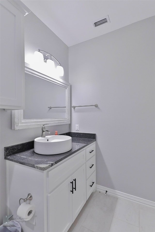 bathroom with tile flooring and vanity