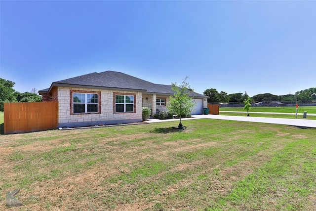 ranch-style home with a garage and a front yard