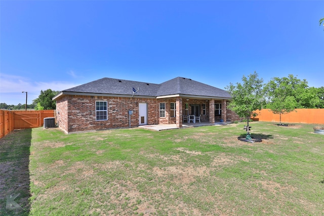 back of property with a patio area, central AC unit, and a lawn