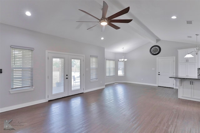 unfurnished living room with dark hardwood / wood-style flooring, lofted ceiling with beams, french doors, and ceiling fan with notable chandelier