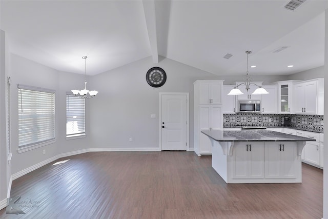 kitchen with decorative light fixtures, white cabinets, tasteful backsplash, and dark wood-type flooring