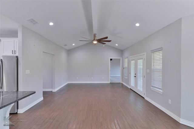 unfurnished living room featuring lofted ceiling, french doors, dark hardwood / wood-style floors, and ceiling fan