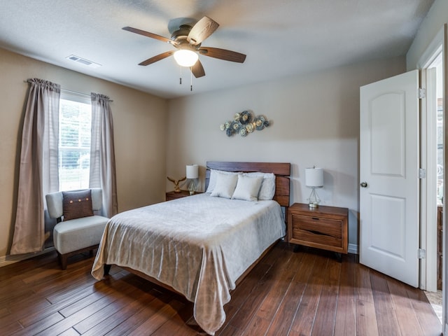 bedroom with ceiling fan and dark hardwood / wood-style flooring