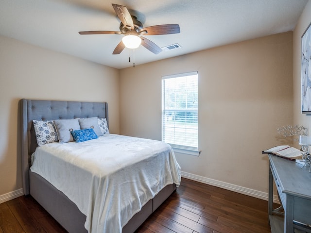 bedroom with dark hardwood / wood-style floors and ceiling fan