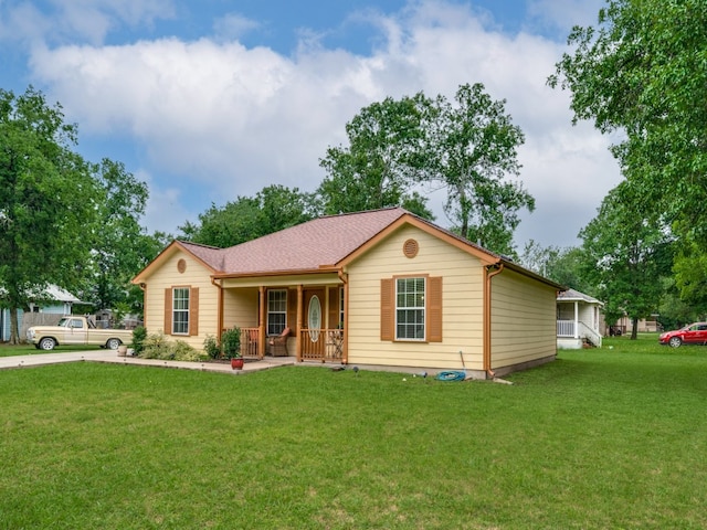 ranch-style home with a front yard and a porch