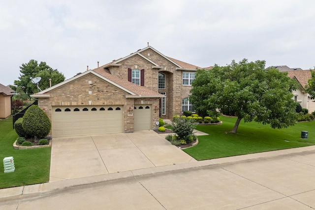 view of front of property with a garage and a front lawn