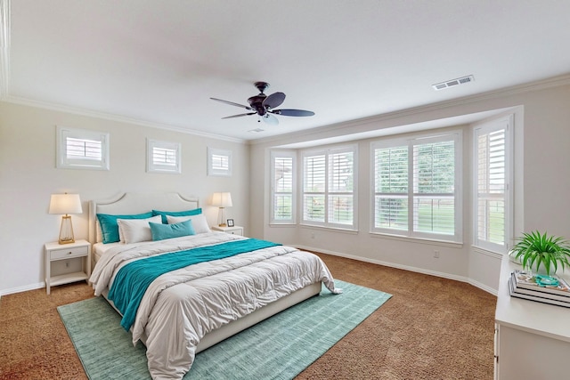 carpeted bedroom with ceiling fan and crown molding