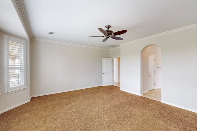 unfurnished room featuring ceiling fan, light colored carpet, and crown molding