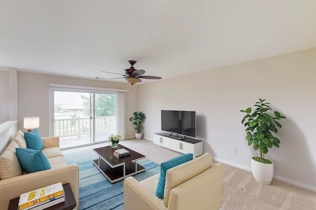 carpeted living room with ceiling fan