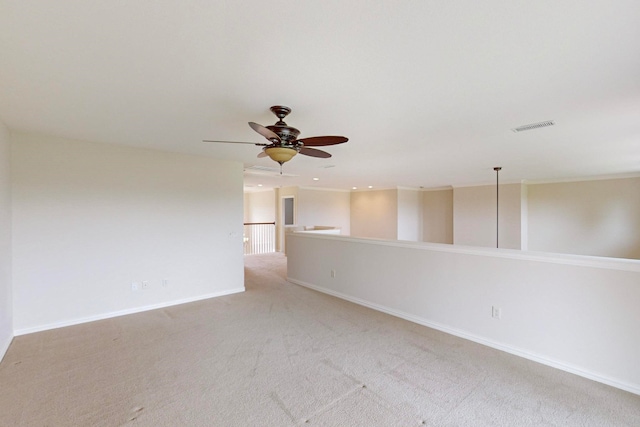 carpeted spare room with ceiling fan