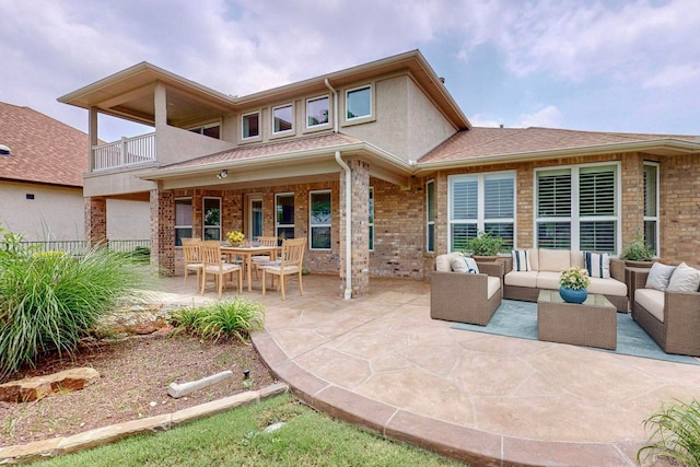 rear view of house featuring a balcony, an outdoor hangout area, and a patio area