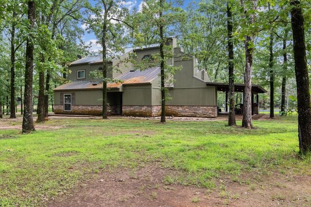 rear view of house featuring a lawn