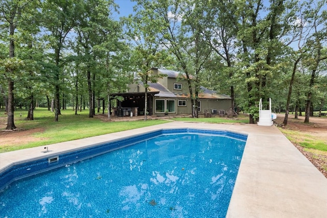 view of pool with a lawn