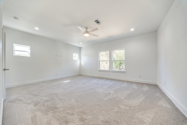 carpeted spare room with ceiling fan and a healthy amount of sunlight