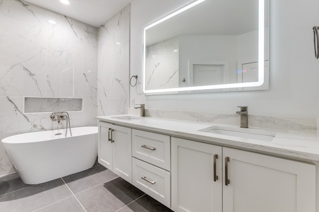 bathroom with vanity, tile patterned floors, and a tub