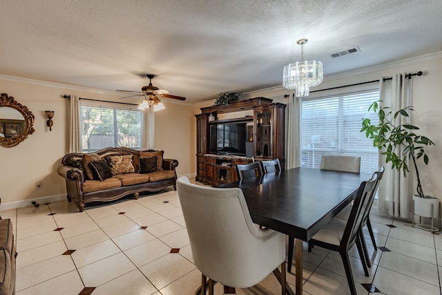 tiled dining room with ceiling fan with notable chandelier, a textured ceiling, and crown molding