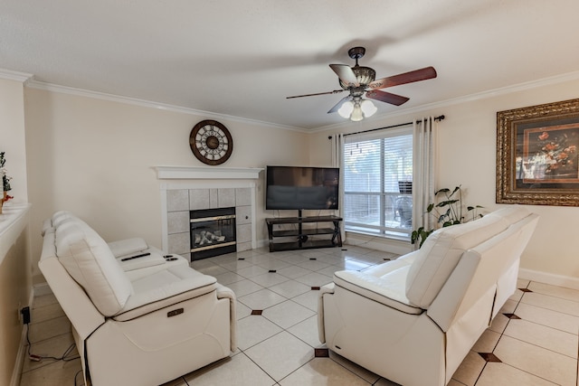 tiled living room with ornamental molding, a tiled fireplace, and ceiling fan