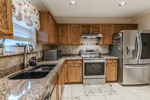 kitchen with sink, tasteful backsplash, light tile patterned floors, exhaust hood, and appliances with stainless steel finishes