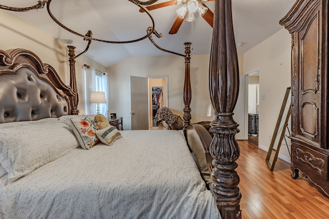 bedroom featuring ceiling fan, lofted ceiling, and light hardwood / wood-style floors