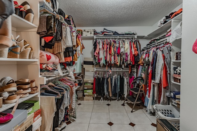 spacious closet featuring light tile patterned floors