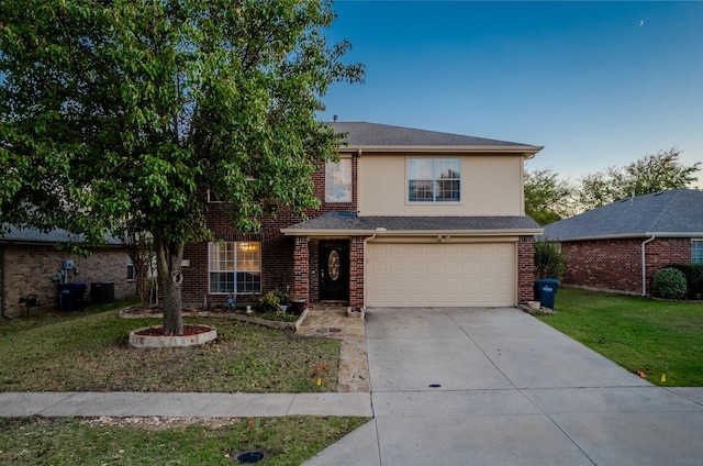 view of front property featuring a garage and a front lawn