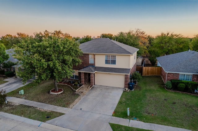 view of front of house featuring a garage and a lawn