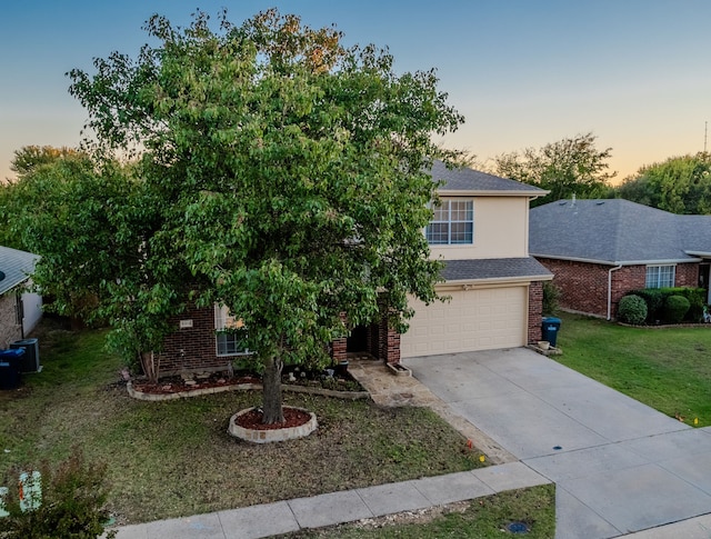 view of front of property featuring a lawn and a garage