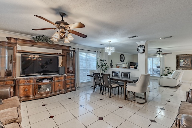 dining space featuring a wealth of natural light, ornamental molding, and ceiling fan with notable chandelier