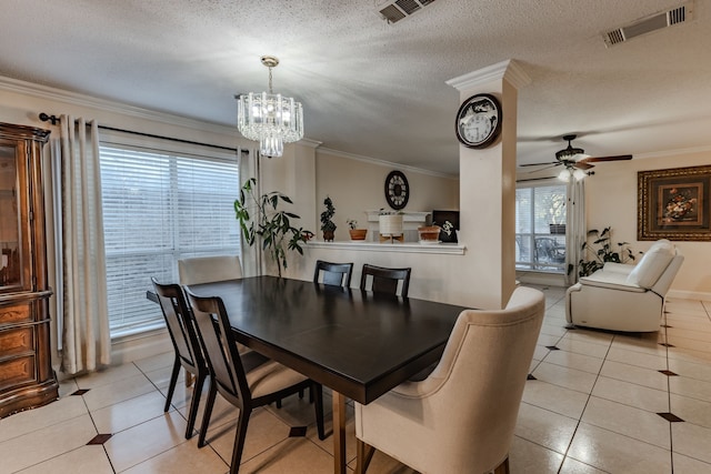 dining space featuring ceiling fan with notable chandelier, a textured ceiling, light tile patterned floors, and crown molding