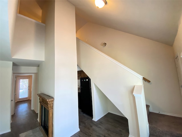 staircase with lofted ceiling and dark hardwood / wood-style flooring