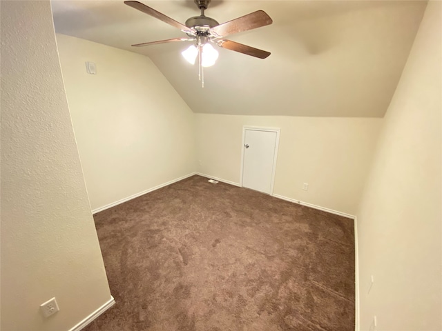 bonus room with ceiling fan, dark colored carpet, and lofted ceiling