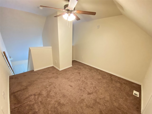 bonus room featuring ceiling fan, dark colored carpet, and lofted ceiling