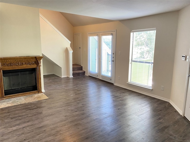 unfurnished living room with dark hardwood / wood-style floors and plenty of natural light