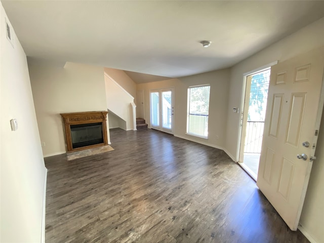 unfurnished living room featuring dark hardwood / wood-style floors