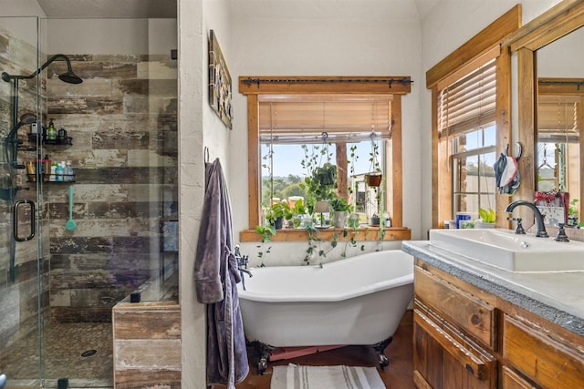 bathroom featuring vanity and shower with separate bathtub