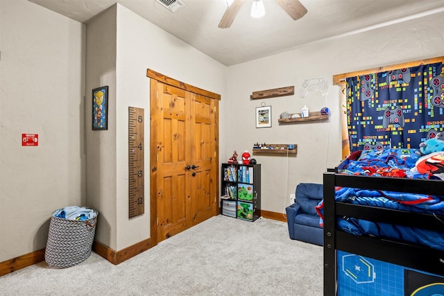 carpeted bedroom with a ceiling fan, visible vents, and baseboards