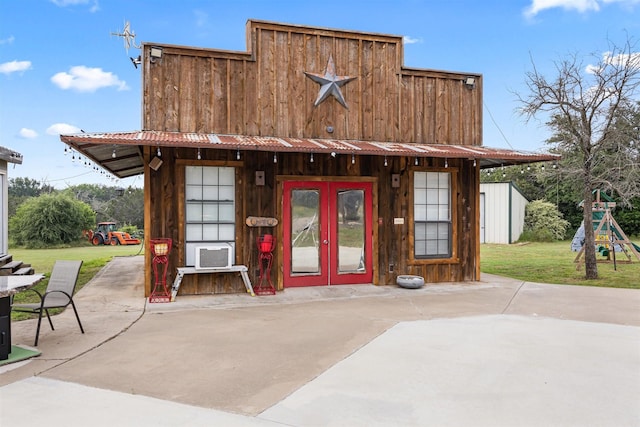 back of house featuring french doors, an outbuilding, cooling unit, a patio area, and a yard