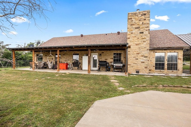 back of house featuring a patio area and a yard