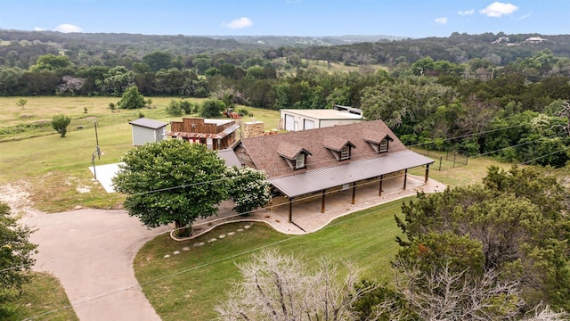 drone / aerial view featuring a view of trees