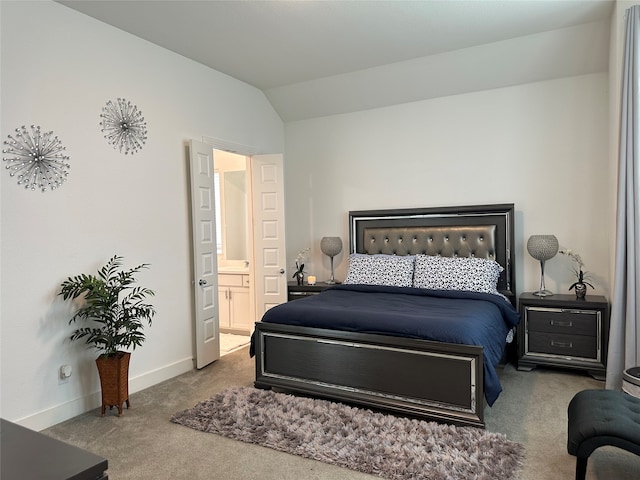 carpeted bedroom with lofted ceiling and ensuite bathroom