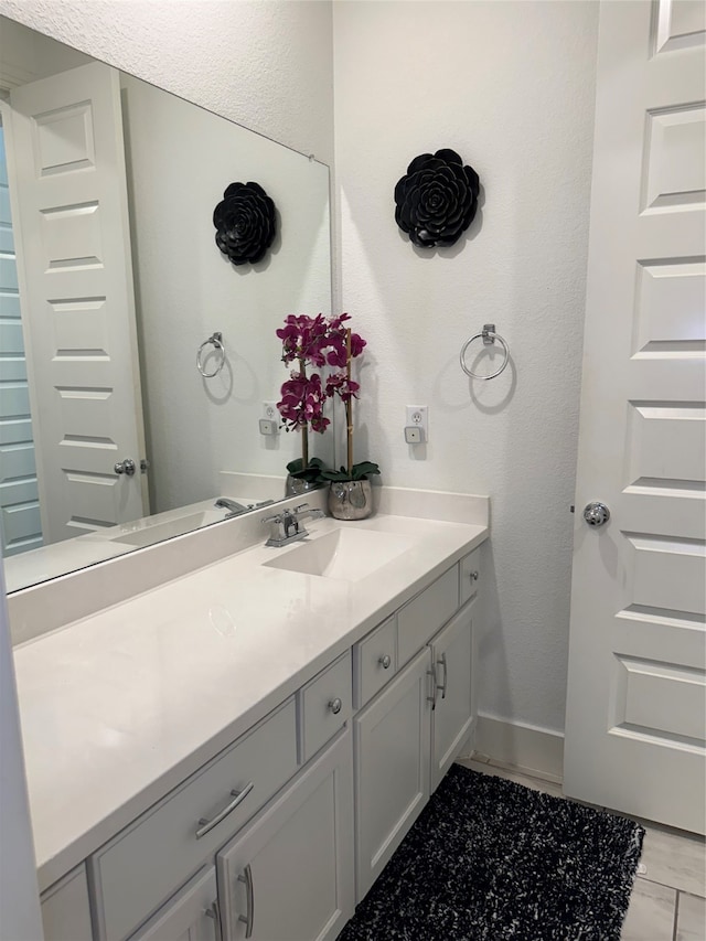 bathroom with tile floors and vanity