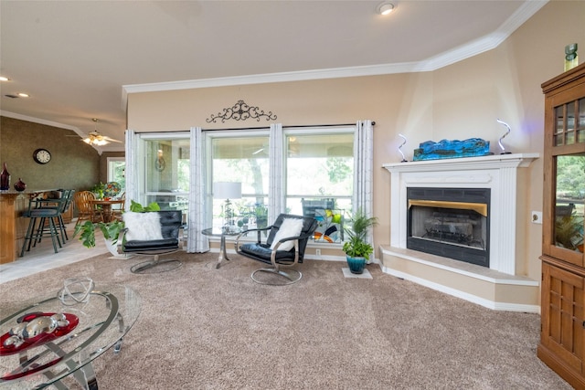 carpeted living room with ceiling fan and crown molding