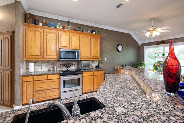 kitchen featuring crown molding, sink, vaulted ceiling, and appliances with stainless steel finishes